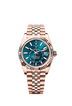 The Oyster Perpetual Sky-Dweller in 18 kt Everose gold with a blue-green dial and a Jubilee bracelet.